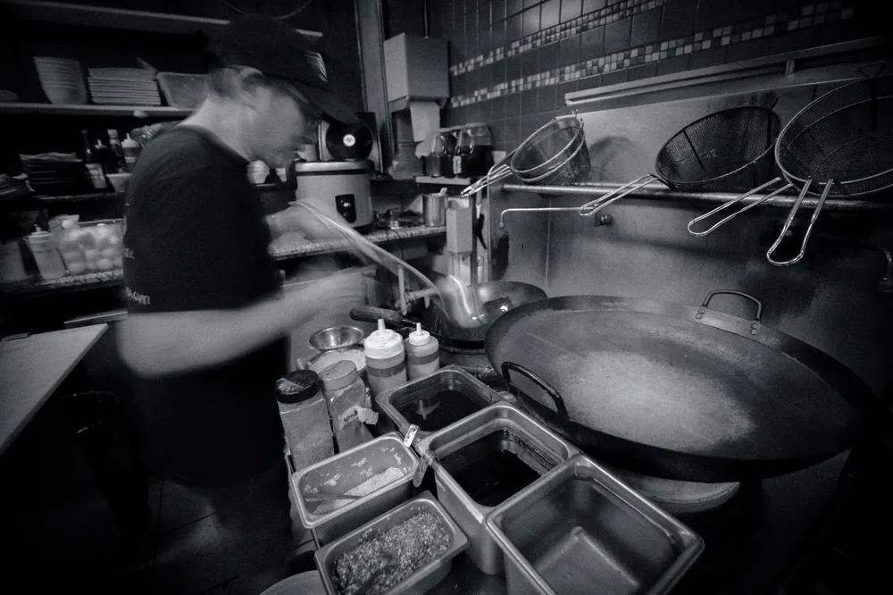 Maya Thai Cuisine team preparing dishes in the kitchen