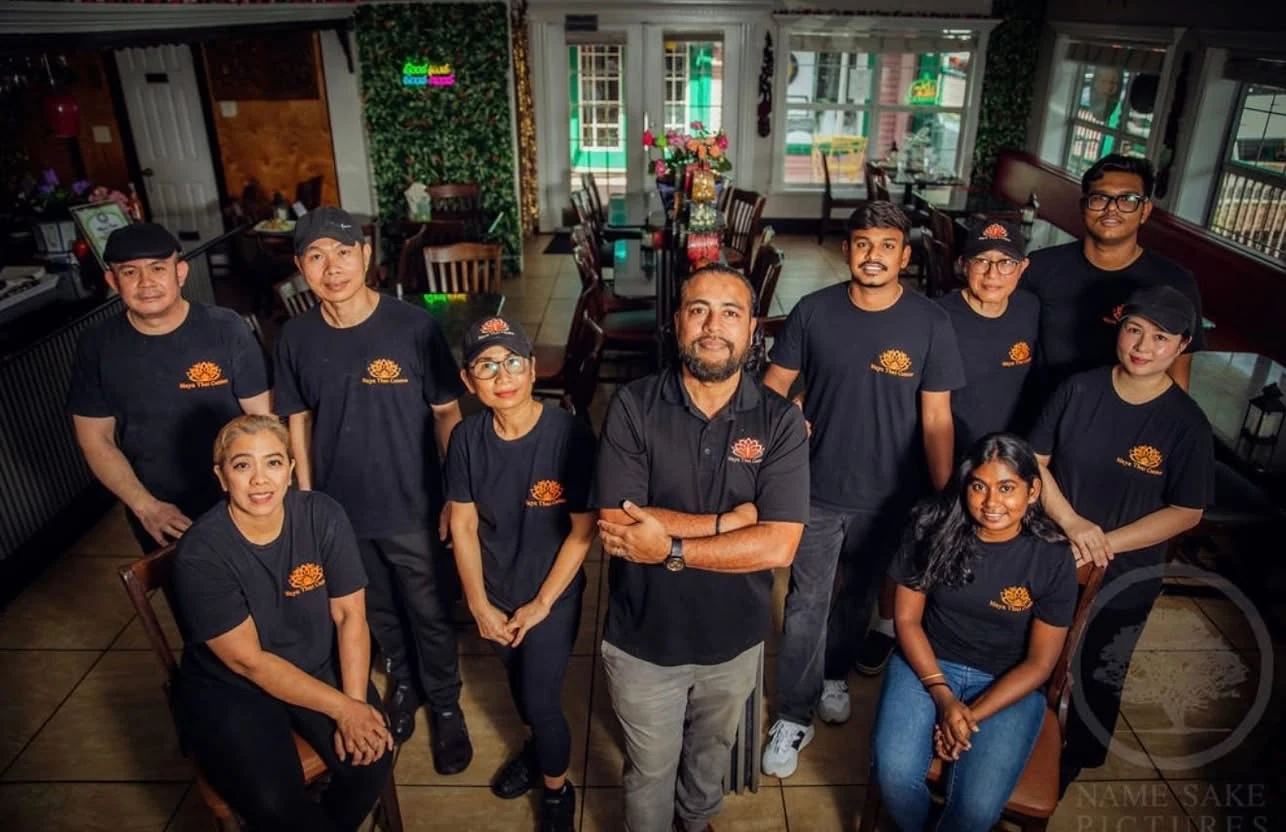 Maya Thai Cuisine team standing together inside a restaurant